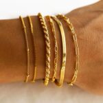 Six 14K gold plated bracelets, including herringbone, Cuban, and paperclip chains, displayed together.