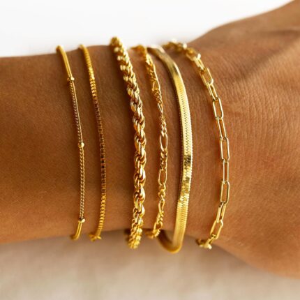 Six 14K gold plated bracelets, including herringbone, Cuban, and paperclip chains, displayed together.