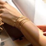 Six 14K gold plated bracelets, including herringbone, Cuban, and paperclip chains, displayed together.