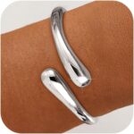 Close-up of an Eaciy 14K gold plated chunky twist cuff bangle bracelet with a polished silver finish.