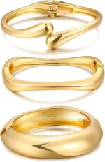 Three iF YOU 14K gold plated chunky bangle bracelets stacked together on a wrist, showing their round shape.