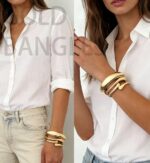 Three iF YOU 14K gold plated chunky bangle bracelets stacked together on a wrist, showing their round shape.