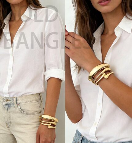 Three iF YOU 14K gold plated chunky bangle bracelets stacked together on a wrist, showing their round shape.