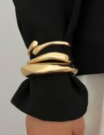 Three iF YOU 14K gold plated chunky bangle bracelets stacked together on a wrist, showing their round shape.