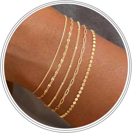 Close-up of MBW Dainty Gold Layering Bracelet Set, showing a mix of thin chains and small beads on a wrist.
