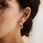 A pair of SHERLOVE Chunky Knot Gold Drop Earrings, 14K gold plated, showcasing their unique knot design and dangle style.