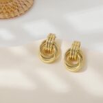 A pair of SHERLOVE Chunky Knot Gold Drop Earrings, 14K gold plated, showcasing their unique knot design and dangle style.