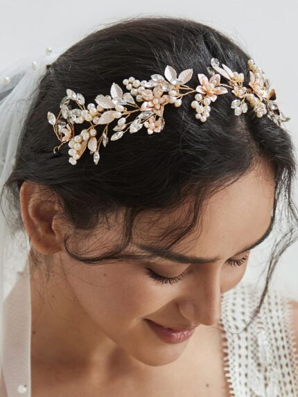 Close-up of a gold SWEETV bridal headband featuring delicate flower and leaf designs with pearls and rhinestones.