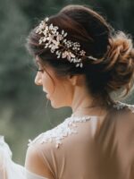 Close-up of a gold SWEETV bridal headband featuring delicate flower and leaf designs with pearls and rhinestones.