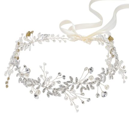 Close-up of a silver bridal headpiece featuring delicate metal leaves, luminous pearls, and sparkling clear rhinestones.
