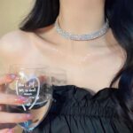 Close-up of a Tatibana Crystal Wedding Jewelry Set featuring a silver necklace and matching earrings with sparkling crystals.