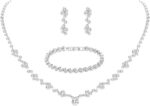 Close-up of a silver-plated necklace and matching earrings adorned with clear round rhinestones, presented in a gift box.